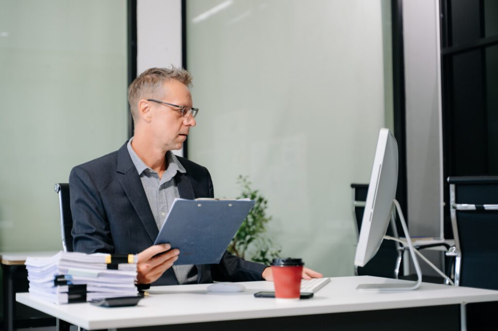 Mature business man executive manager looking at laptop watching online webinar training or